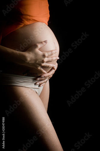 Young female in third trimester of pregnancy.