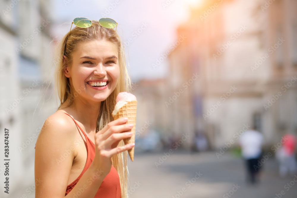 Cheerful girl eating ice cream cone Cheerful girl eating ice cream cone