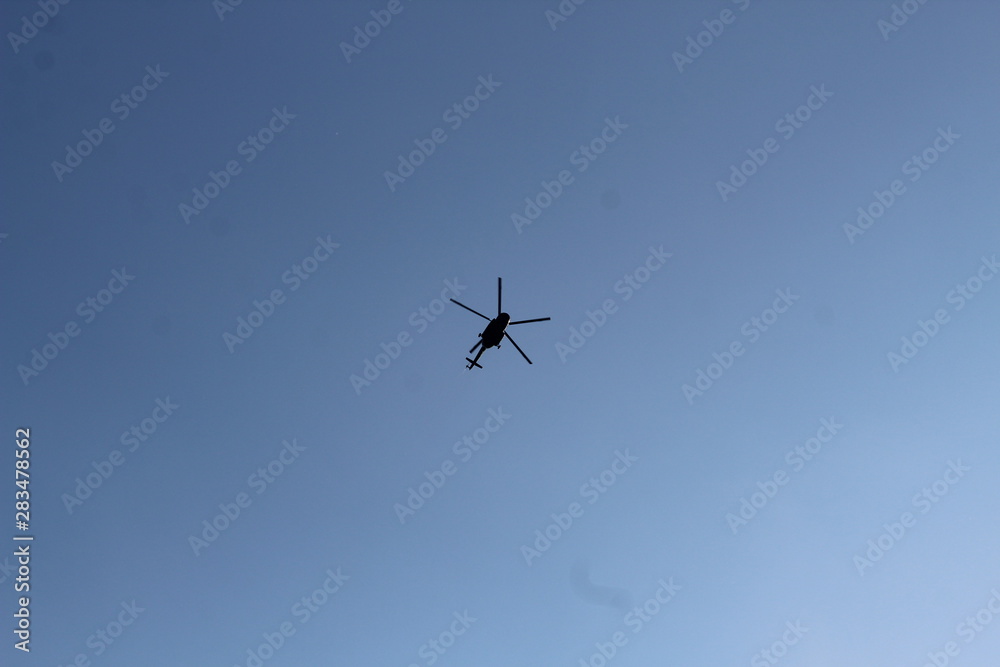 large military helicopter hovers in sky. A camouflaged helicopter flies at high speed. large military helicopter hovers in sky. A camouflaged helicopter flies at high speed.