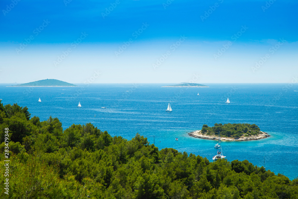 Panoramic view on Kosirina lagoon on Murter island in Croatia, sailing boats and yachts on blue seascape