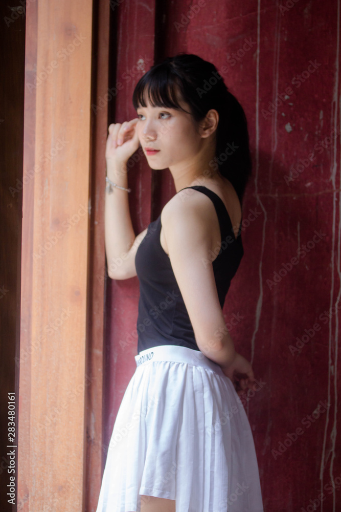 Portrait of thai adult beautiful girl black shirt white skirt relax time