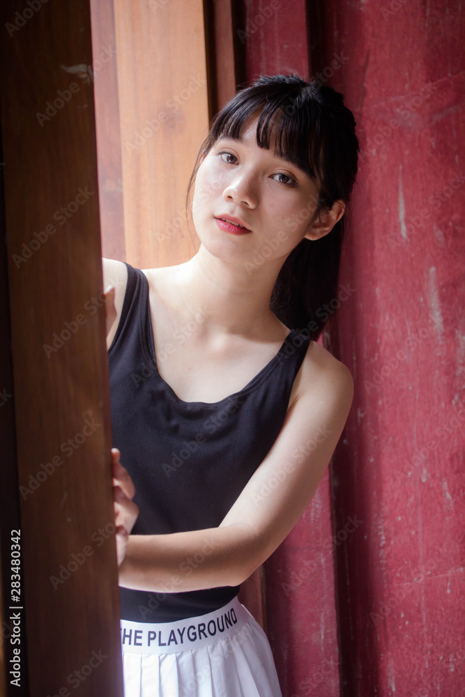 Portrait of thai adult beautiful girl black shirt white skirt relax time Portrait of thai adult beautiful girl black shirt white skirt relax time