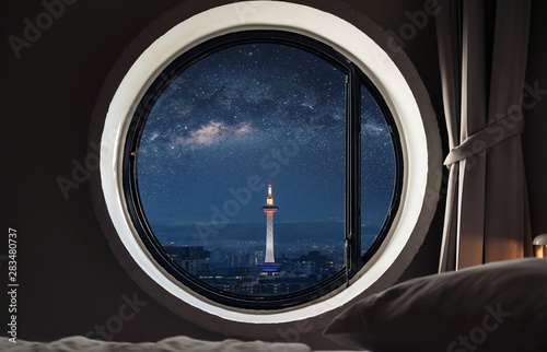 Papier peint Looking through window, Kyoto city view with starry sky at night in Japan