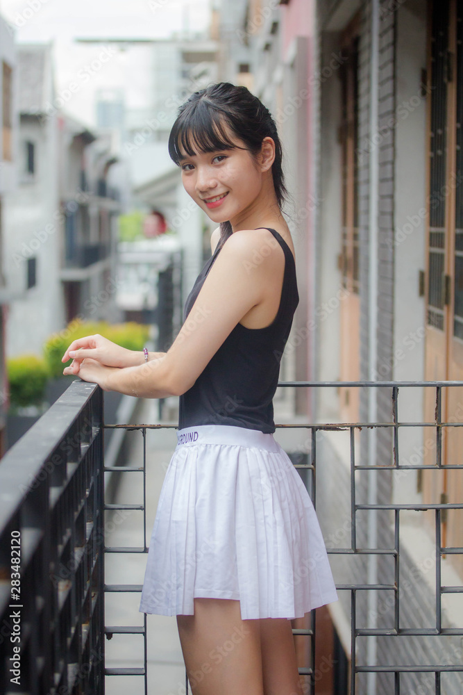 Portrait of thai adult beautiful girl black shirt white skirt relax time Portrait of thai adult beautiful girl black shirt white skirt relax time