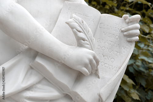 Sculpture writing into the book of laws