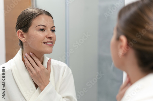 Wallpaper Mural Woman in bathrobe looking in mirror at bathroom Torontodigital.ca