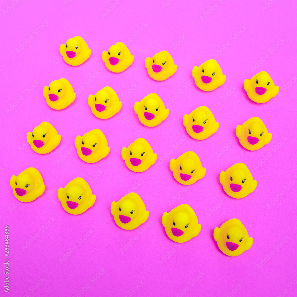 Duck toys on a pink background. Minimal flat lay art Duck toys on a pink background. Minimal flat lay art