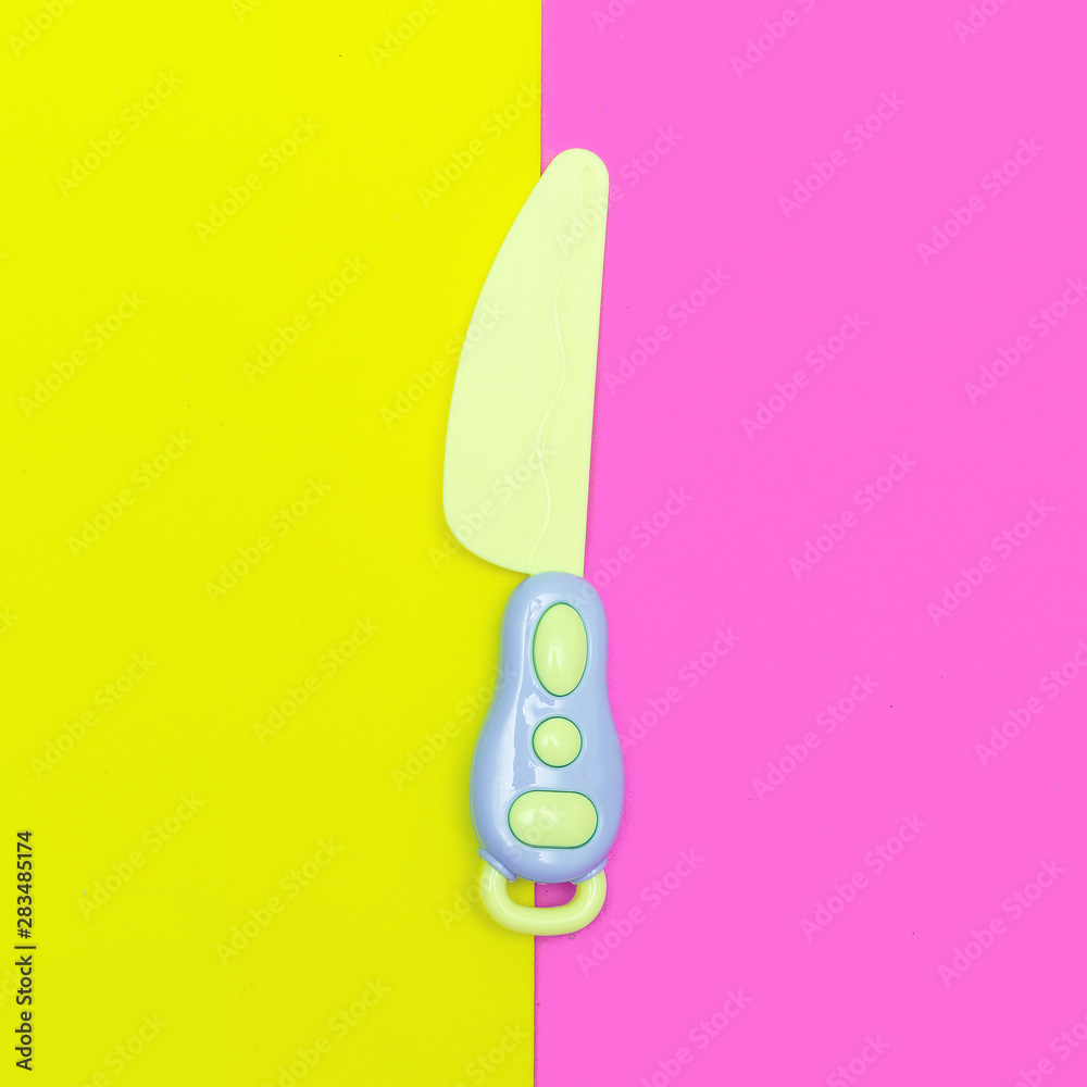 Toy plastic knife. Minimal flat lay art Toy plastic knife. Minimal flat lay art