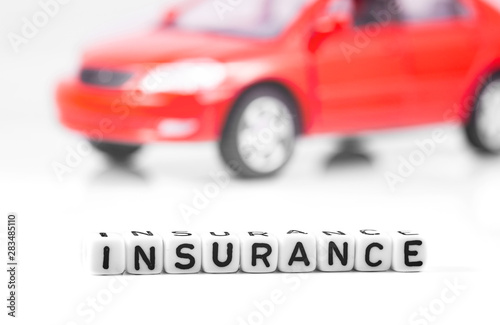 Car insurance. Concept in blocks with word insurance and red car