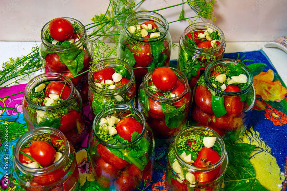 pickling tomatoes in stacked jars