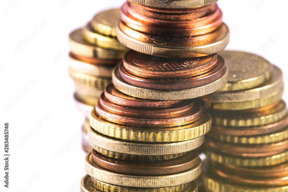 closeup rows of metal coins on the white background closeup rows of metal coins on the white background