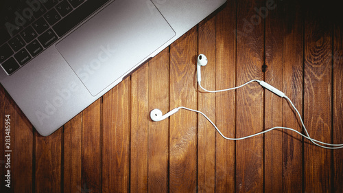 desk with Apple Macbook and Earpods. Apple Inc. is an American multinational technology company. Moscow, Russia - April 9, 2019