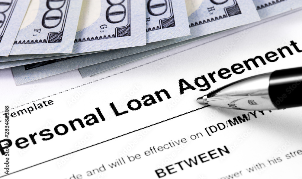 personal loan agreement application form with pen and money, dollars