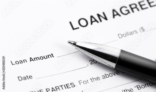 personal loan application form with black pen closeup macro