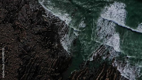 Rotating aerial shot of rocky beach at Widemouth Bay, Cornwall. photo