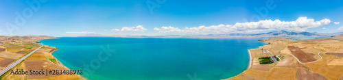 Aerial view of Lake Van the largest lake in Turkey, lies in the far east of that country in the provinces of Van and Bitlis. Fields and cliffs overlooking the crystal waters. Roads along the lake