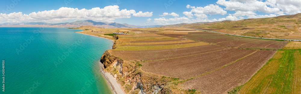 Aerial view of Lake Van the largest lake in Turkey, lies in the far east of that country in the provinces of Van and Bitlis. Fields and cliffs overlooking the crystal clear waters
