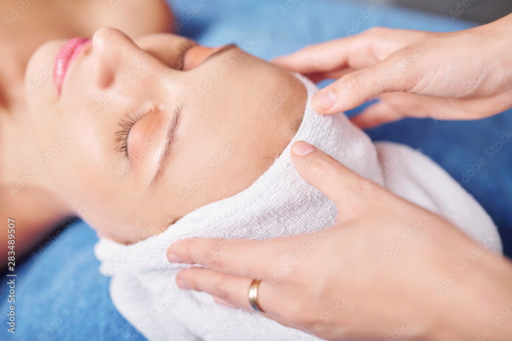 © DragonImages - Close-up image of hairdresser wiping hair of pretty female client with tower after wash © DragonImages - Close-up image of hairdresser wiping hair of pretty female client with tower after wash