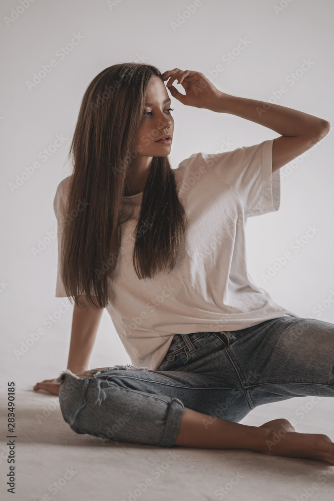 Sexy hot woman in shirt and jeans posing in studio on cube on white  background. Seductive glamour young girl model portrait. Stock Photo |  Adobe Stock