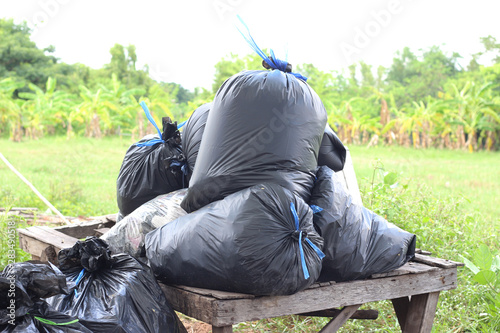 Black plastic garbage bags in the park