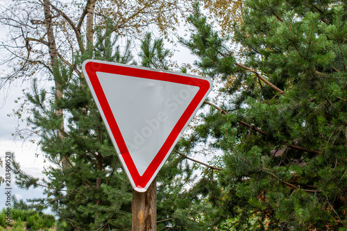 Dented road sign give way