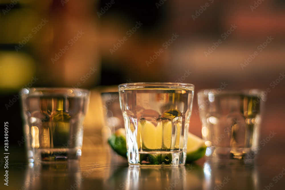 wodka shots on wooden table closeup wodka shots on wooden table closeup