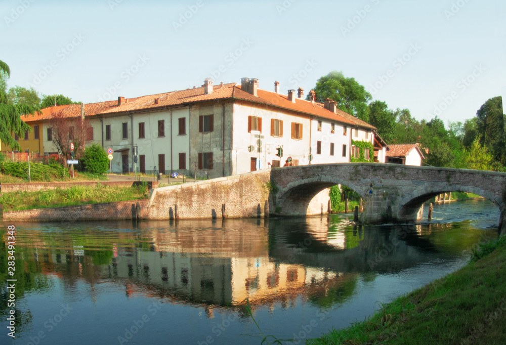 summer landscape,medieval bridge over the Naviglio Grande near Milan. italy