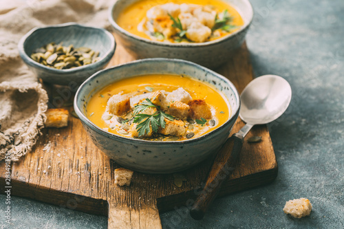 Canvas Print Pumpkin soup in a bowl with croutons and pumpkin seeds.