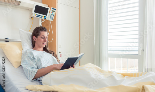 Woman in hospital bed reading the bible