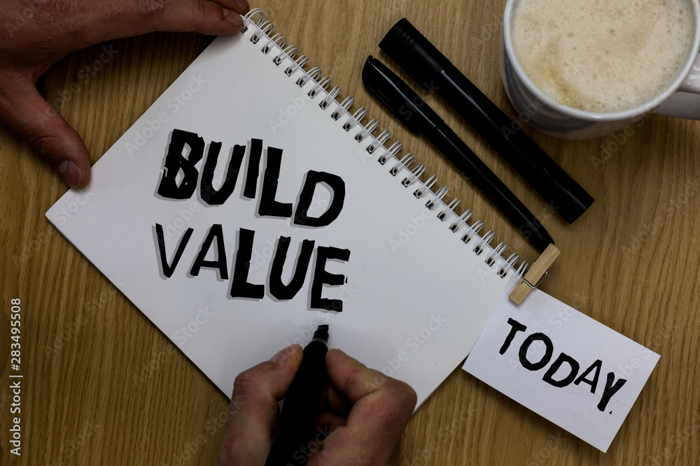 Writing note showing Build Value. Business photo showcasing efficient enough way that it will generate profit after cost Man holding marker notebook clothepin reminder wooden table cup coffee Writing note showing Build Value. Business photo showcasing efficient enough way that it will generate profit after cost Man holding marker notebook clothepin reminder wooden table cup coffee