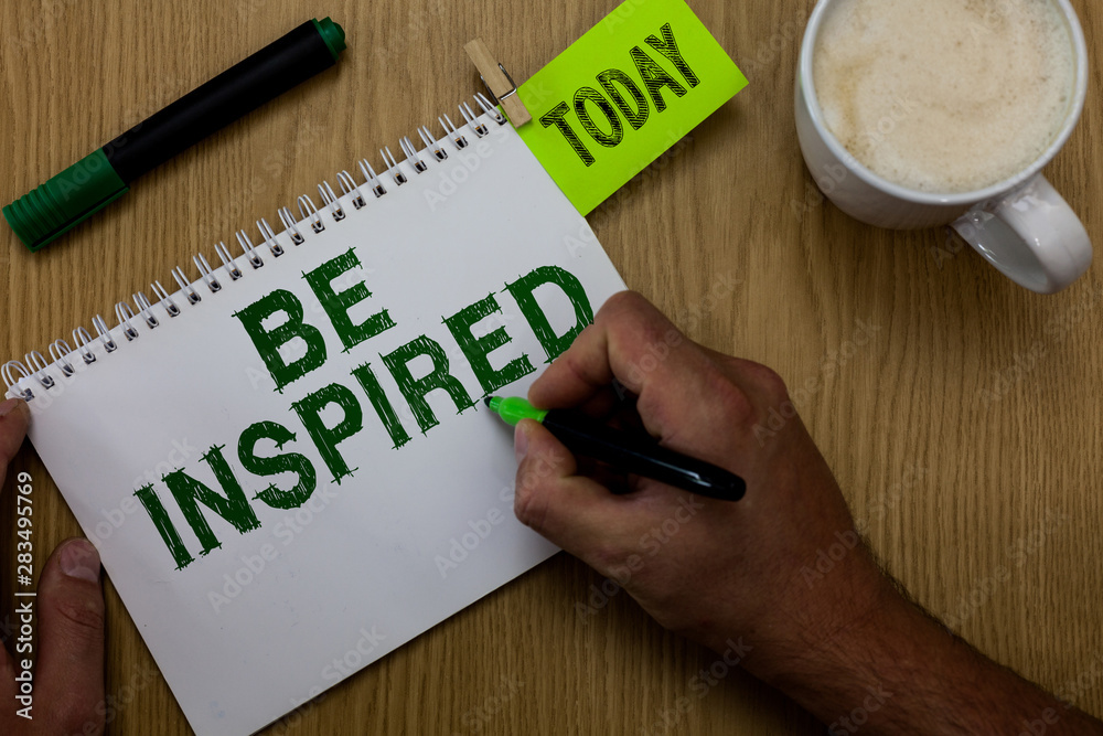 Conceptual hand writing showing Be Inspired. Business photo showcasing extraordinary quality as arising from some creative impulse Man holding marker notebook reminder wooden table cup coffee Conceptual hand writing showing Be Inspired. Business photo showcasing extraordinary quality as arising from some creative impulse Man holding marker notebook reminder wooden table cup coffee