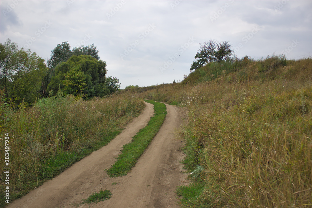 rural dirt road going to the hill