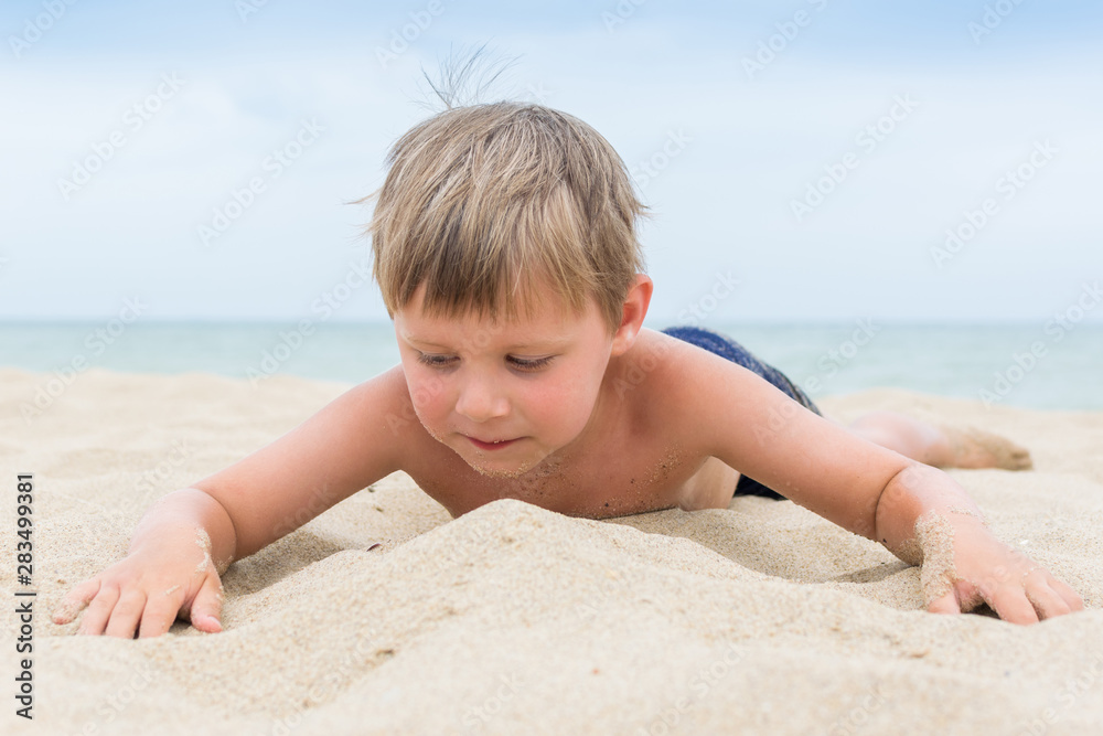 A little boy is having fun on the beach. Rest of the child on the sea, ocean. A little boy is having fun on the beach. Rest of the child on the sea, ocean.