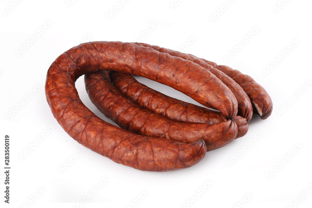 Smoked thin sausage on a white background. Food product. Smoked thin sausage on a white background. Food product.