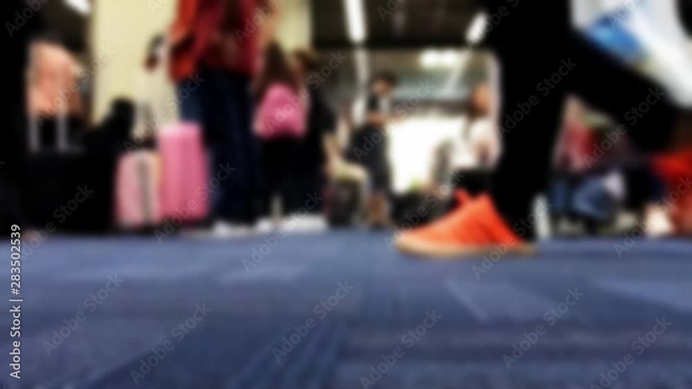 The detailed view of legs walks on carpet in hall, accelerated motion. A blurred passengers on to the airport. The detailed view of legs walks on carpet in hall, accelerated motion. A blurred passengers on to the airport.
