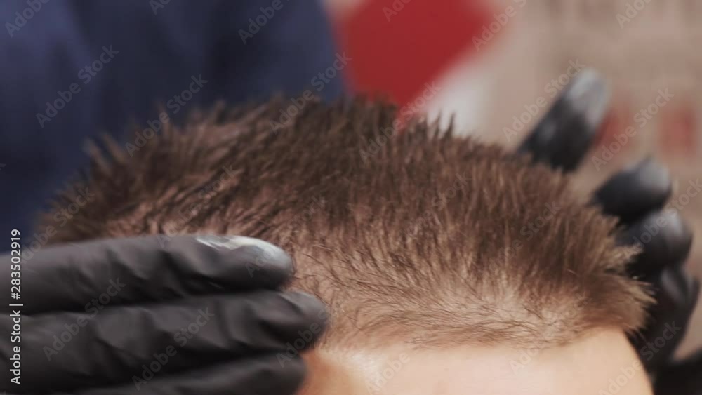 Close up of male hands of hairstylist. Men's hairstyling in a barbershop or hair salon. Barbershop. Close up of male hands of hairstylist. Men's hairstyling in a barbershop or hair salon. Barbershop.