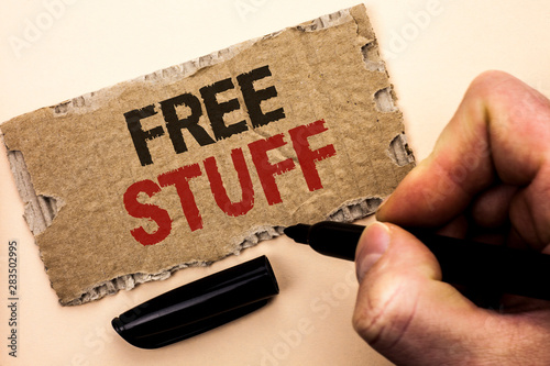 Writing note showing Free Stuff. Business photo showcasing Complementary Free of Cost Chargeless Gratis Costless Unpaid written by Man Holding Marker tear Cardboard Piece Plain Background. photo