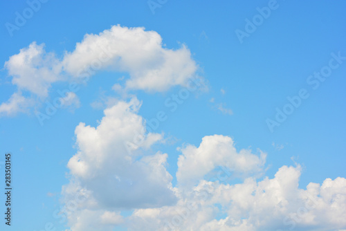 Bright and colorful photos of heavenly angelic white clouds and blue  blue sky with sunlight. Light  delicate and airy cloudy background with white and blue lights and colors.