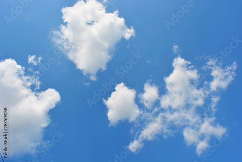 Bright and colorful photos of heavenly angelic white clouds and blue, blue sky with sunlight. Light, delicate and airy cloudy background with white and blue lights and colors.