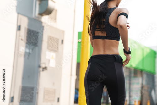 Cropped image of a young woman athlete jogging