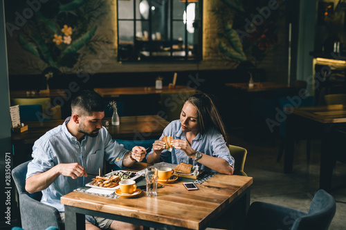 romantic couple having breakfast at snack bar