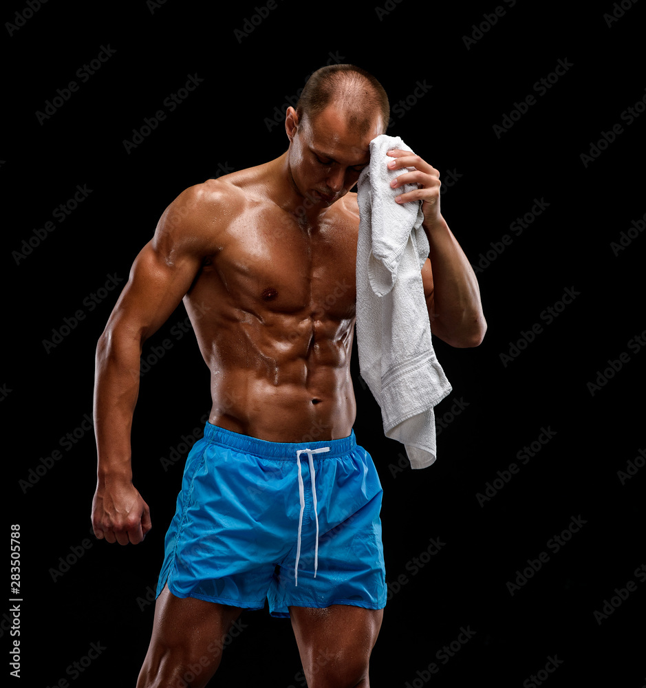 Athletic Men wipe the sweat of his body after workout