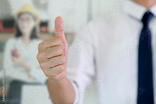 Businessman showing thumbs up - closeup shot.