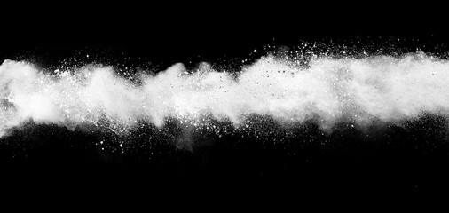 Freeze motion of white color powder exploding on dark background. 