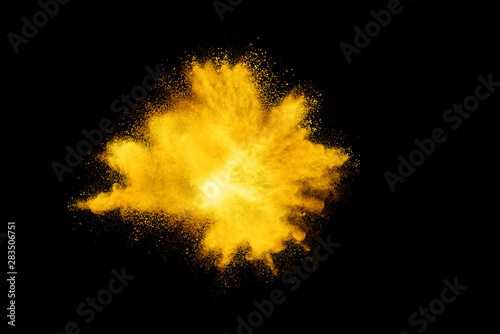 Yellow powder explosion on black background.