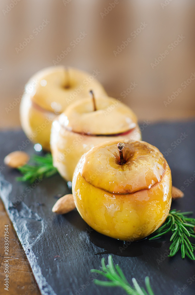 Baked sweet yellow apple with nuts and  berry in sugar glaze