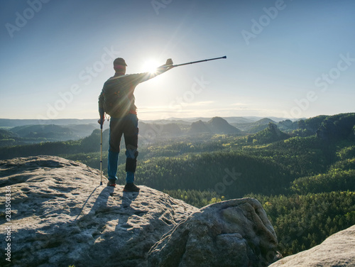 Obraz na płótnie Hiker man with broken leg in immobilizer and crutches