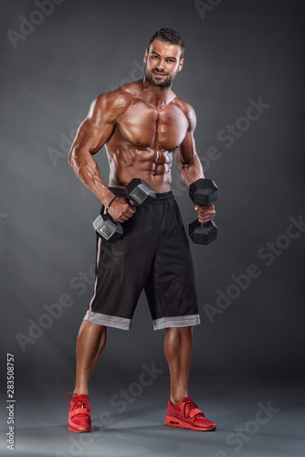 Muscular Athletic Men Exercise With Dumbbells © mrbigphoto
