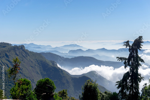 Clouds below the mountains