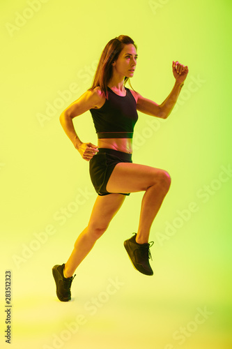 Fototapeta Naklejka Na Ścianę i Meble -  Full length of a beautiful young fitness girl working out